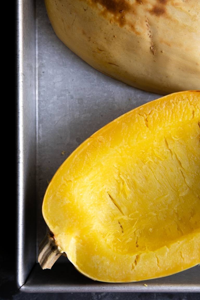 Oven roasted spaghetti squash halves in a baking dish.