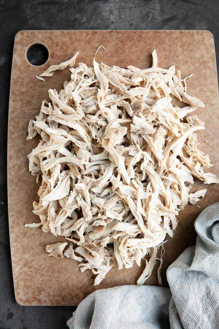 shredded chicken on cutting board