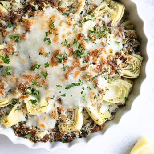 A plate of Artichoke heart with cheese and breadcrumbs