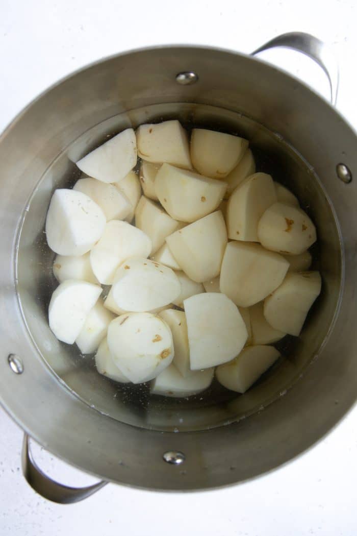 Peeled and chopped Russet potatoes in a large pot covered with cold water.