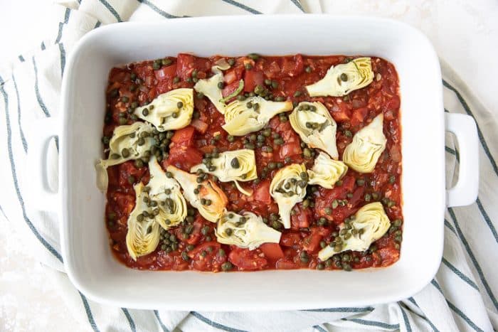 The Mediterranean baked fish sauce in a casserole dish