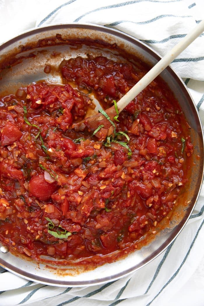 a saucepan with Mediterranean baked fish sauce