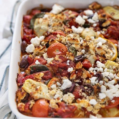 A close up of Mediterranean baked fish in a casserole dish