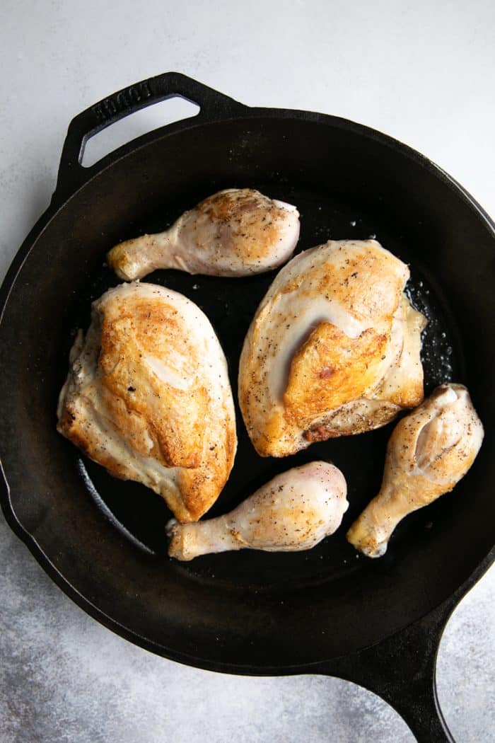 Pan-seared chicken in a cast iron skillet.