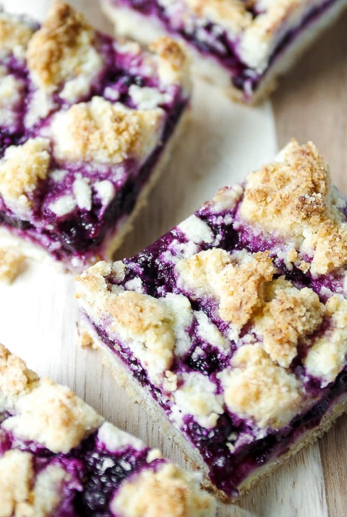 Sliced Blueberry crumble bars on a cutting board