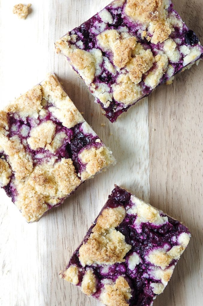 Three cut-out square blueberry crumble bars