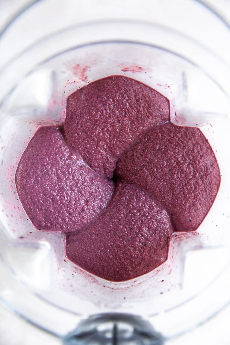 Blender filled with acai smoothie.