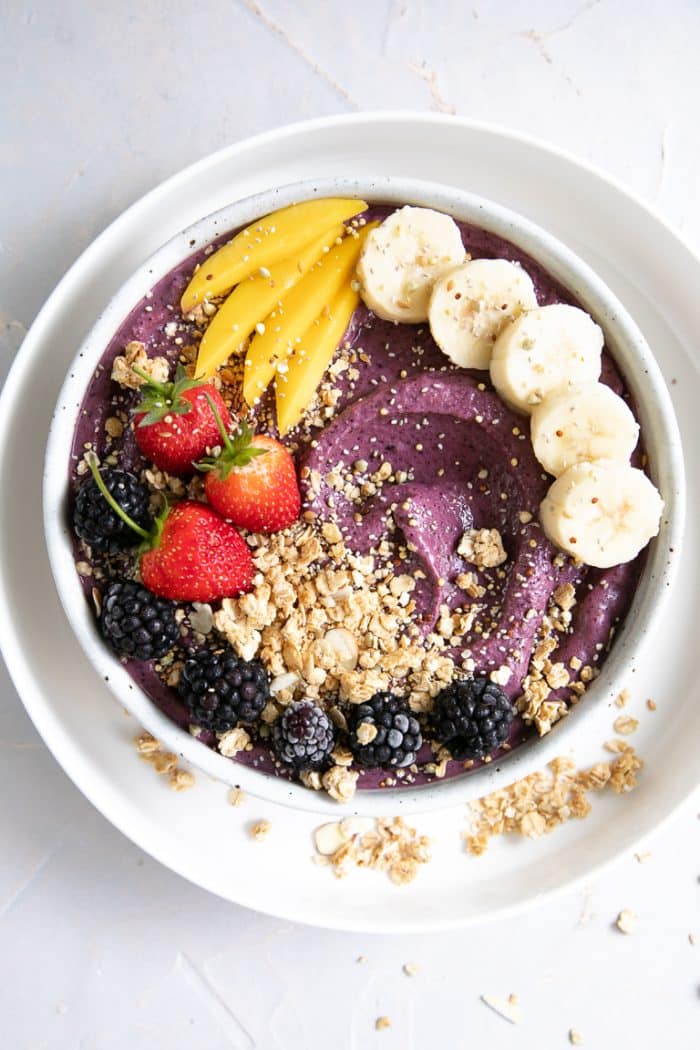 Acai topped with fresh fruit and granola.