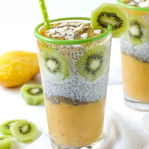 Mango Chia Pudding in a glass with green straw