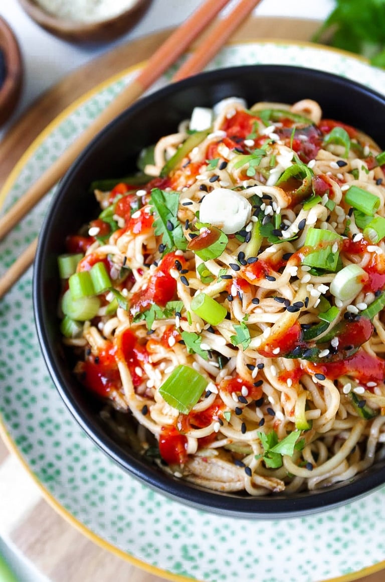 big black bowl filled with healthy ramen noodles and covered in spicy red chili sauce