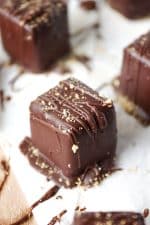 A close up of a piece of chocolate cake on a plate, with Cheesecake