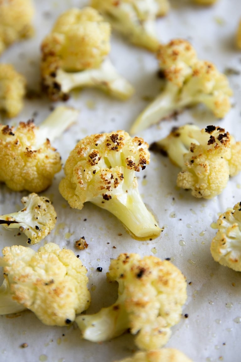 Roasted cauliflower on a large baking sheet.