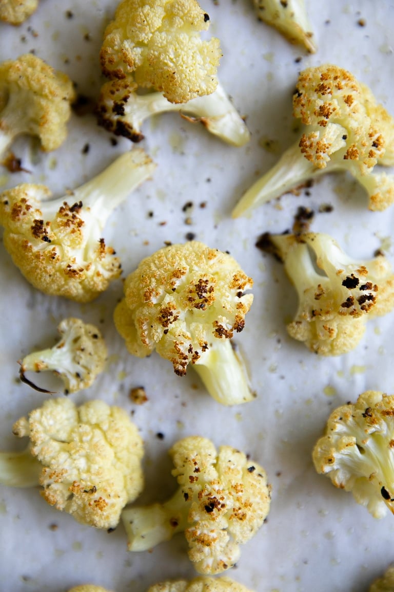 Roasted cauliflower on a large baking sheet.