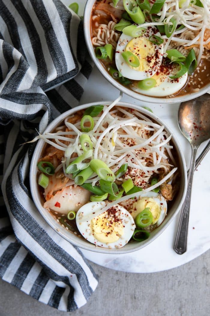 Overhead image of two bowls filled with Kimchi Ramen Noodle Soup