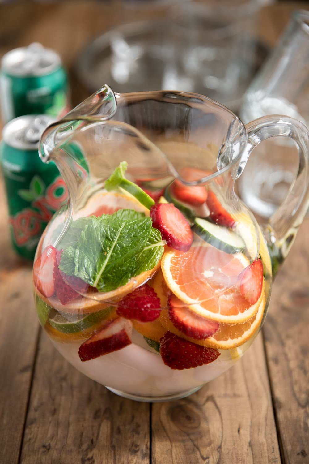 glass pitcher full of fruit and mint