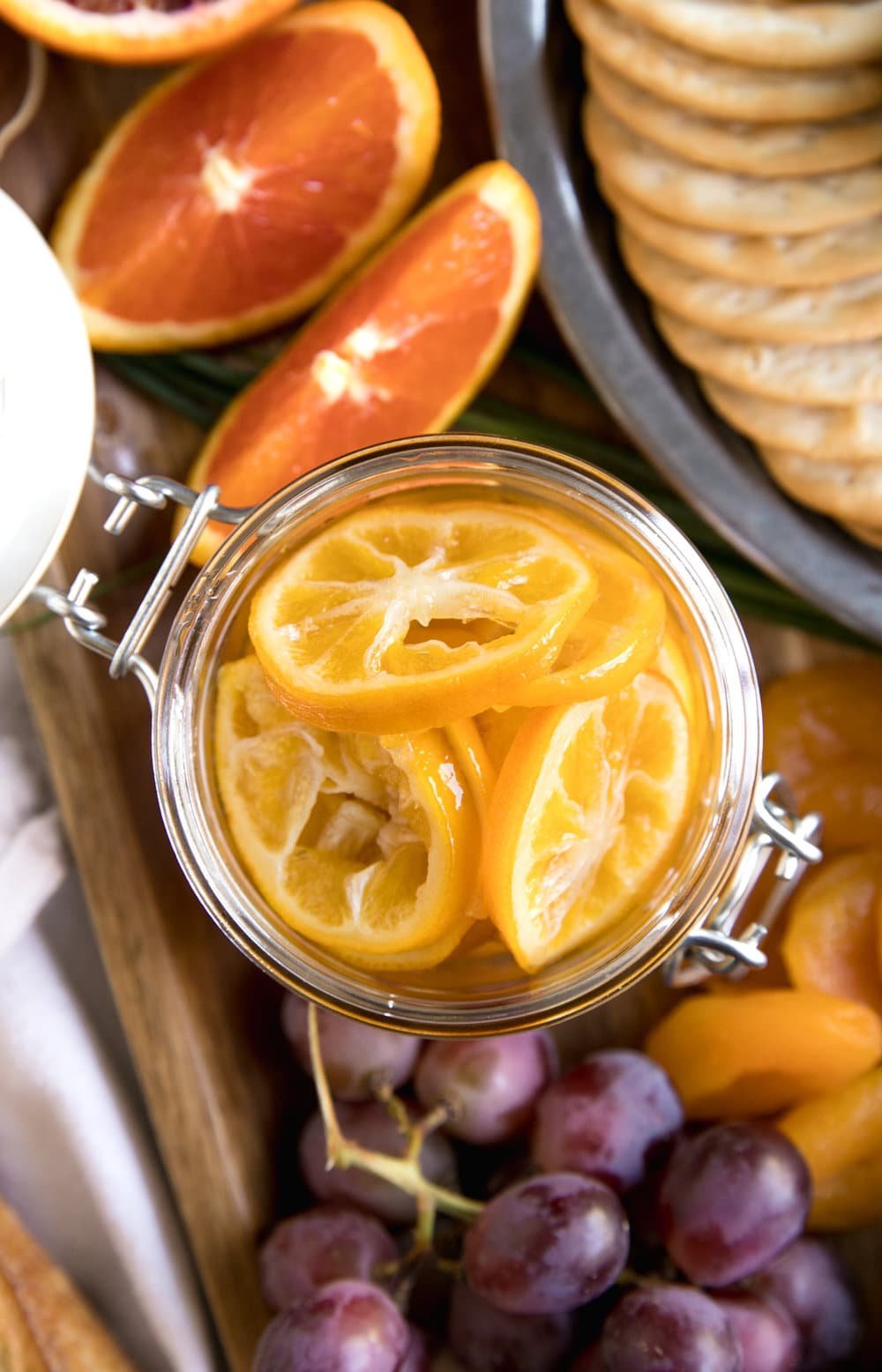oranges in jar among grapes and crackers
