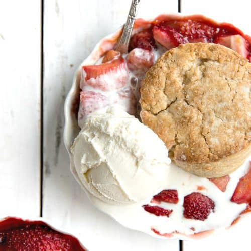 A piece of strawberry rhubarb cobbler with ice cream