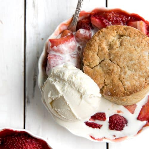 A piece of strawberry rhubarb cobbler with ice cream