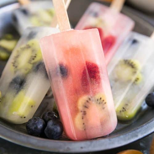 Homemade fruit popsicles on a metal serving tray