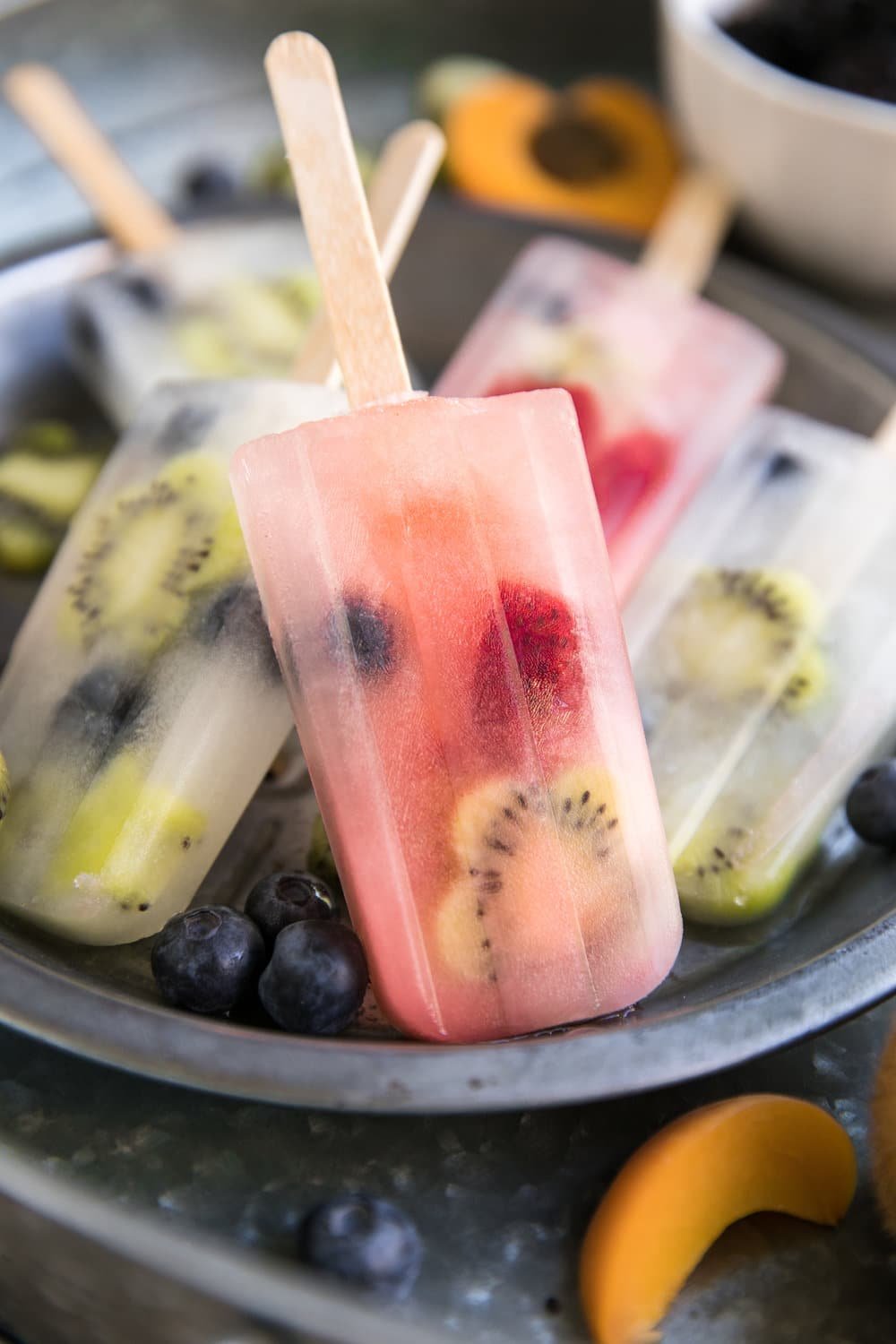 Homemade fruit popsicles on a metal serving tray