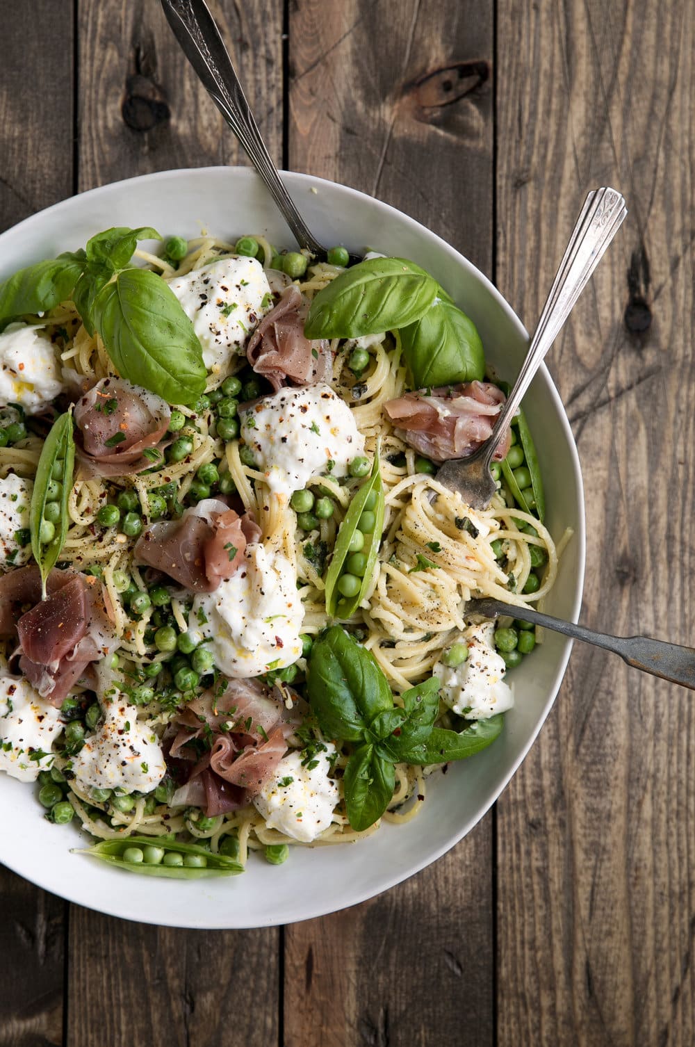 Buttery Pasta in a bowl with cheese, prosciutto, and fresh herbs