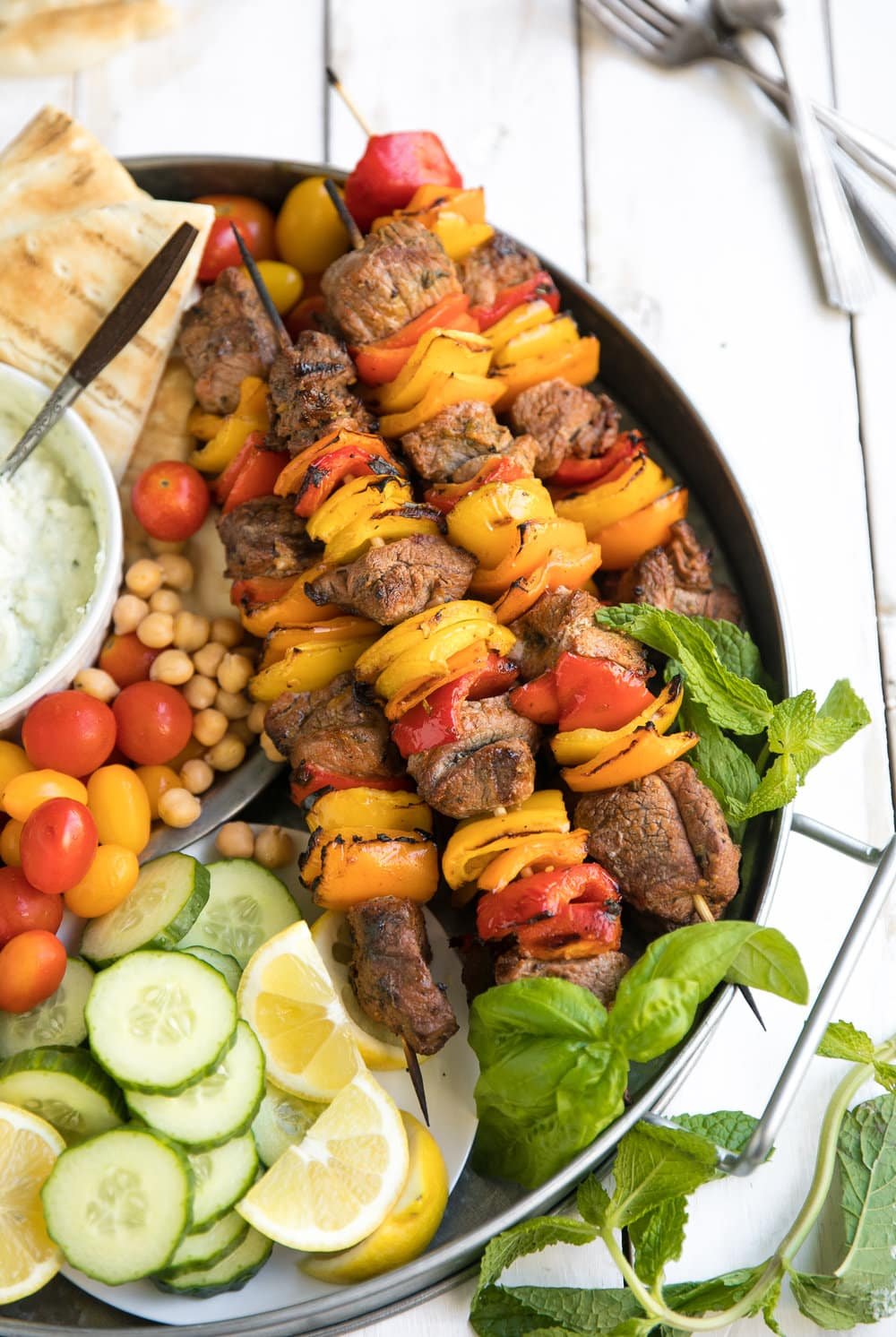 close up of kebabs on Grilled Lamb Kebab Platter with Basil Goat Cheese