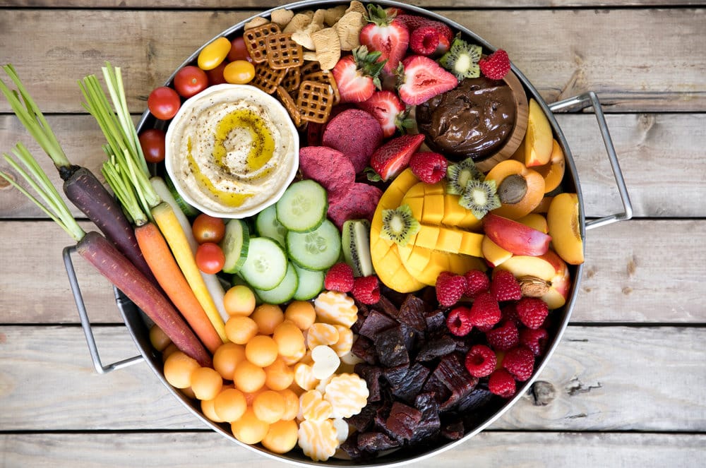 Bright, colorful, and jam-packed with delicious snacks both kids and adults will love, this super easy Kid-Friendly Charcuterie Board will be the highlight of any party! Filled with fresh fruit, cheese, meat snacks, nutella, hummus, and fresh chopped veggies.