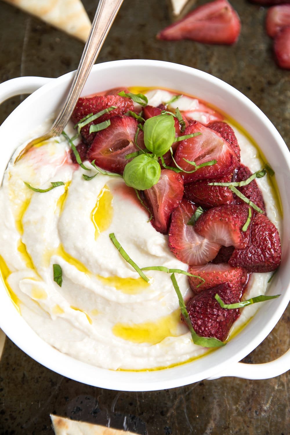 overhead image of Ricotta and White Bean Dip with Roasted Strawberries with flat bread triangles
