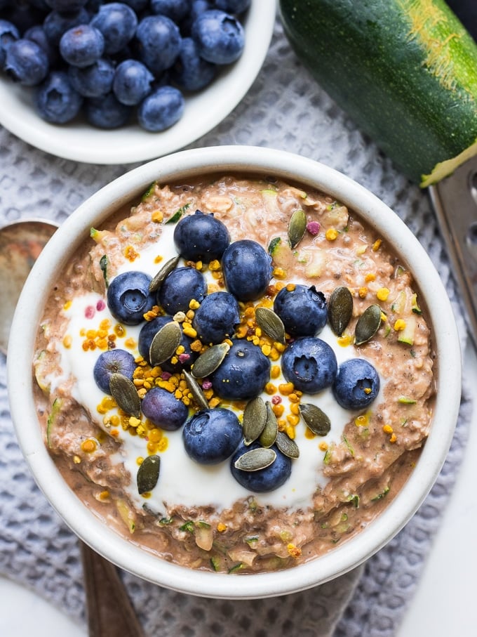 chocolate zucchini overnight oats in white bowl with blueberries
