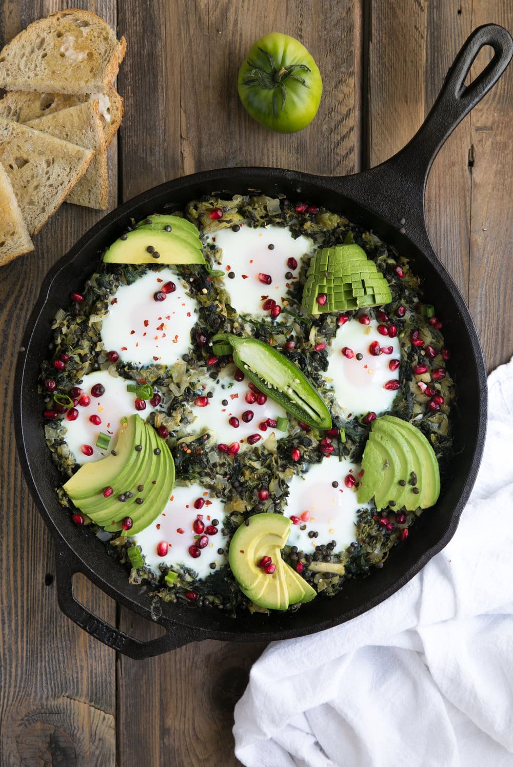 overhead shot of cast iron pan filled with Green Shakshuka