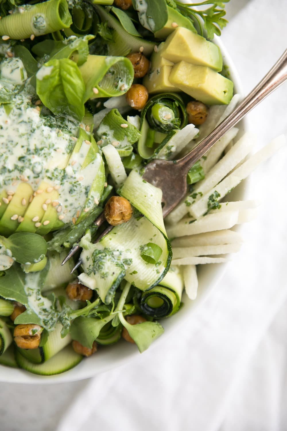 forked zucchini avocado salad with garlic herb dressing and roasted chickpeas
