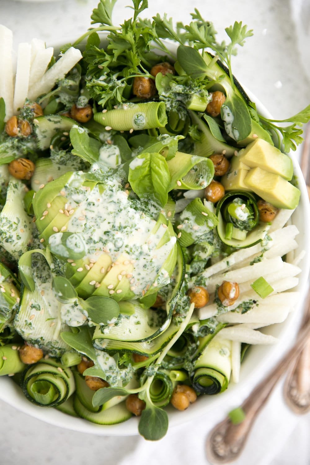 close up image of zucchini avocado salad with garlic herb dressing and roasted chickpeas