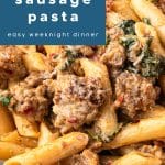 Overhead close-up of creamy sausage pasta with penne, spinach, sun-dried tomatoes, and sausage in a Parmesan cream sauce. Blue text overlay at the top reads “30 minute creamy sausage pasta – easy weeknight dinner.”