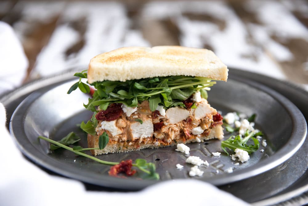 horizontal image of Sun-Dried Tomato Pesto Chicken Salad Sandwich