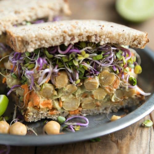 Smashed Avocado and Chickpea Sandwich with Peppery Radish Sprouts Prep Time: 5 minutes | Cook Time: 0 minutes Total Time: 5 minutes Yield: Category: Sandwich/Wrap, Vegetarian, Lunch, Healthy Ingredients 1 ripe avocado 1-2 tablespoons plain Greek yogurt 1/2 cup cooked chickpeas 1 carrot, shredded salt + pepper, to taste 1/4 teaspoon chili flakes (optional) Juice from 1/2 lemon Radish sprouts 2 slices of whole grain bread, or bread of choice Instructions In a medium bowl mash avocado with yogurt until it reaches desired consistency (I prefer mine a little chunkier). Add the cooked chickpeas, shredded carrot (I used a cheese grater to shred mine), salt and pepper, chili flakes and lemon juice. Season to taste. Transfer to one slice of whole grain bread and top with desired amount of radish sprouts (or other sprout of choice) and the other slice of bread. Cut in half and serve.