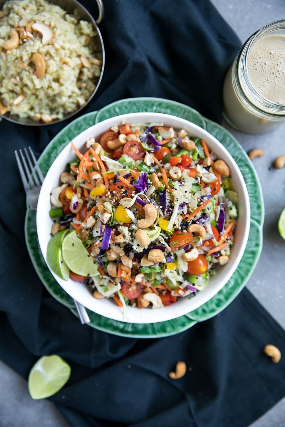 overhead photo of Thai Cashew Coconut Cauliflower Rice Chopped Salad with Ginger Peanut Dressing in side jar