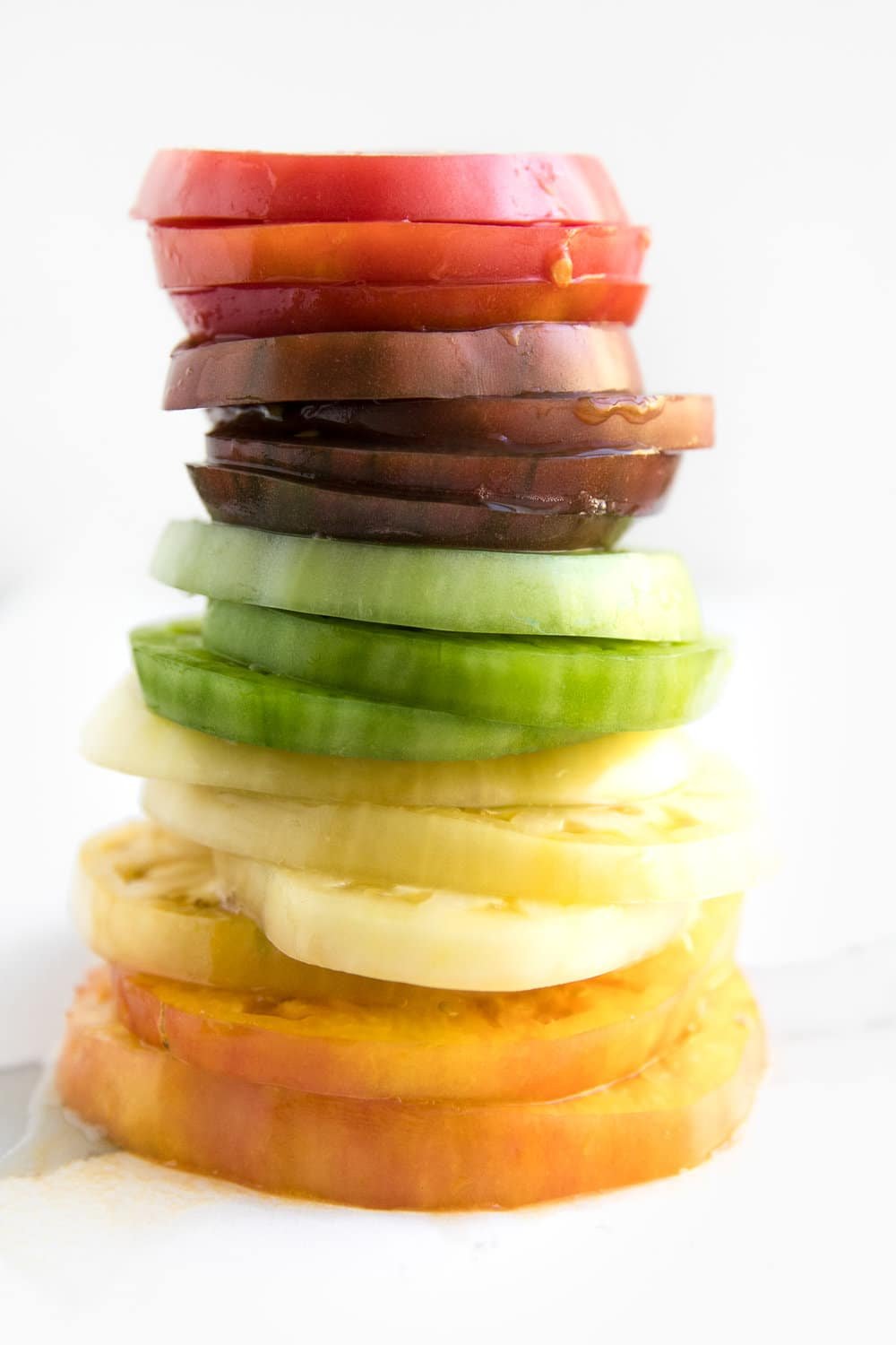 rainbow colored stack of heirloom tomatoes