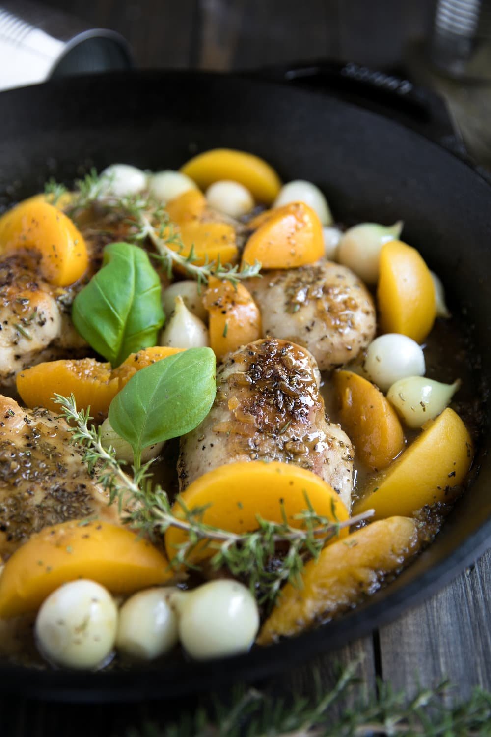 Fresh summer peaches may be on their way out, but that doesn't mean you can't enjoy them all year long in this easy, delicious and super healthy 30 Minute Peach and Chicken Skillet with Pearl Onions.