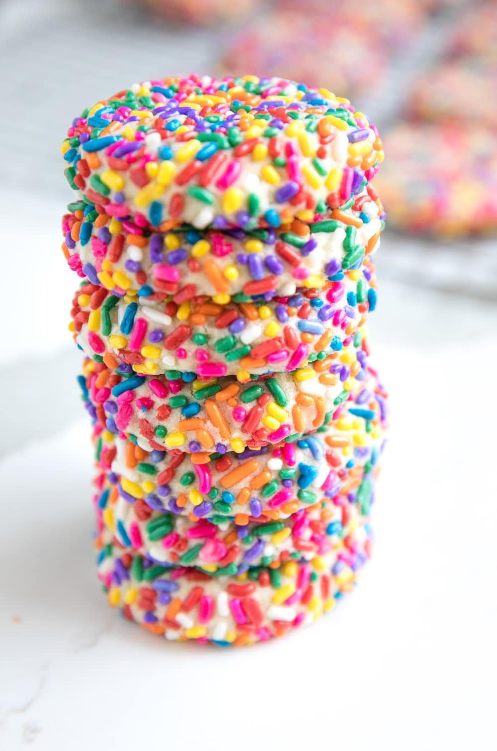 vertical stack of 7 Rainbow Sprinkle Cookies