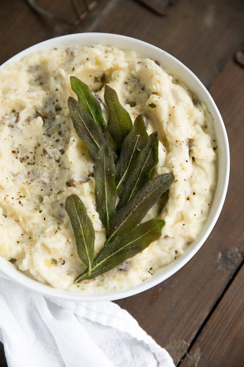 close up photo of bowl with Four Cheese Mashed Potatoes with Crispy Sage on top
