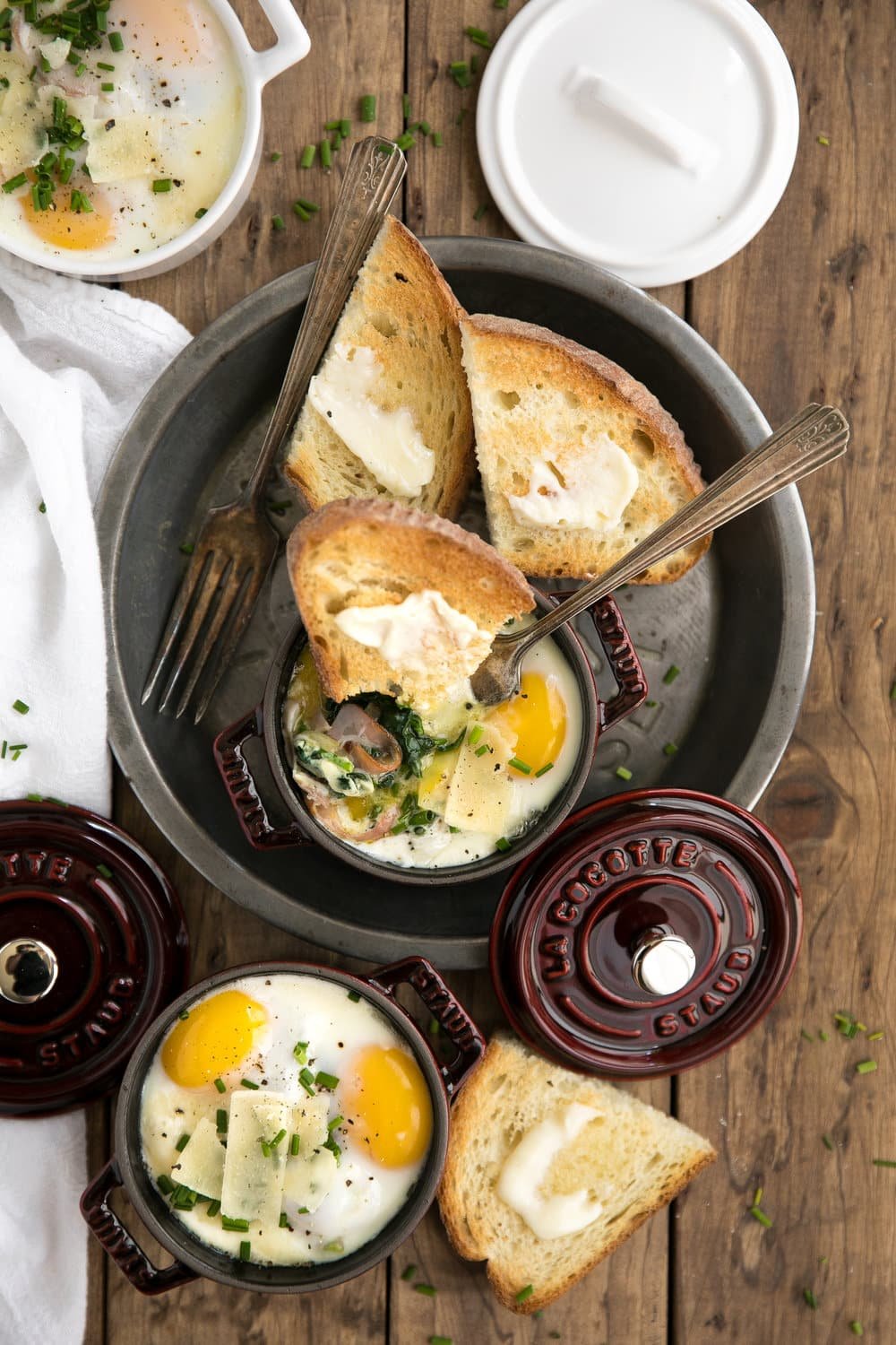 Perfect for entertaining but easy enough to make for just one, these Creamy Baked Eggs in Mini Cocottes with Spinach and prosciutto are delicious, fun-size and the perfect place to dip all the buttered bread.
