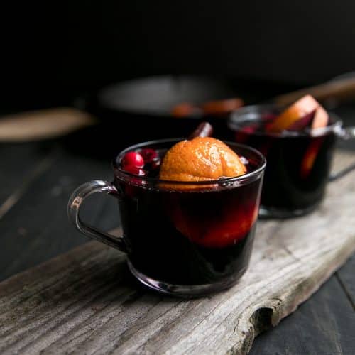 A cup of mulled wine sitting on top of a wooden table