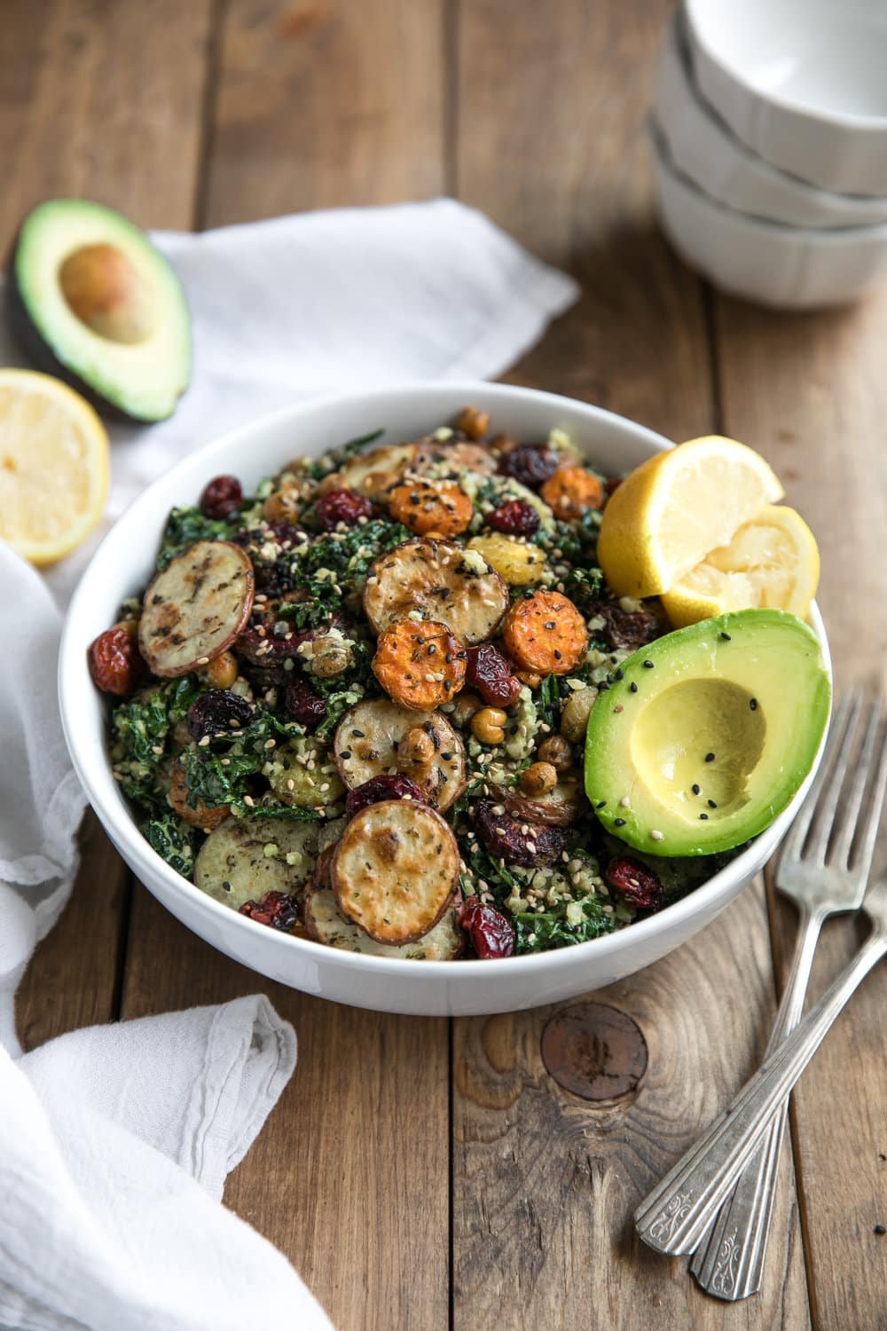 This Kale and Roasted Veggie Salad with Tahini Yogurt Pesto combines healthy, energy-packed power foods like kale, chickpeas, and carrots into one delicious bowl.