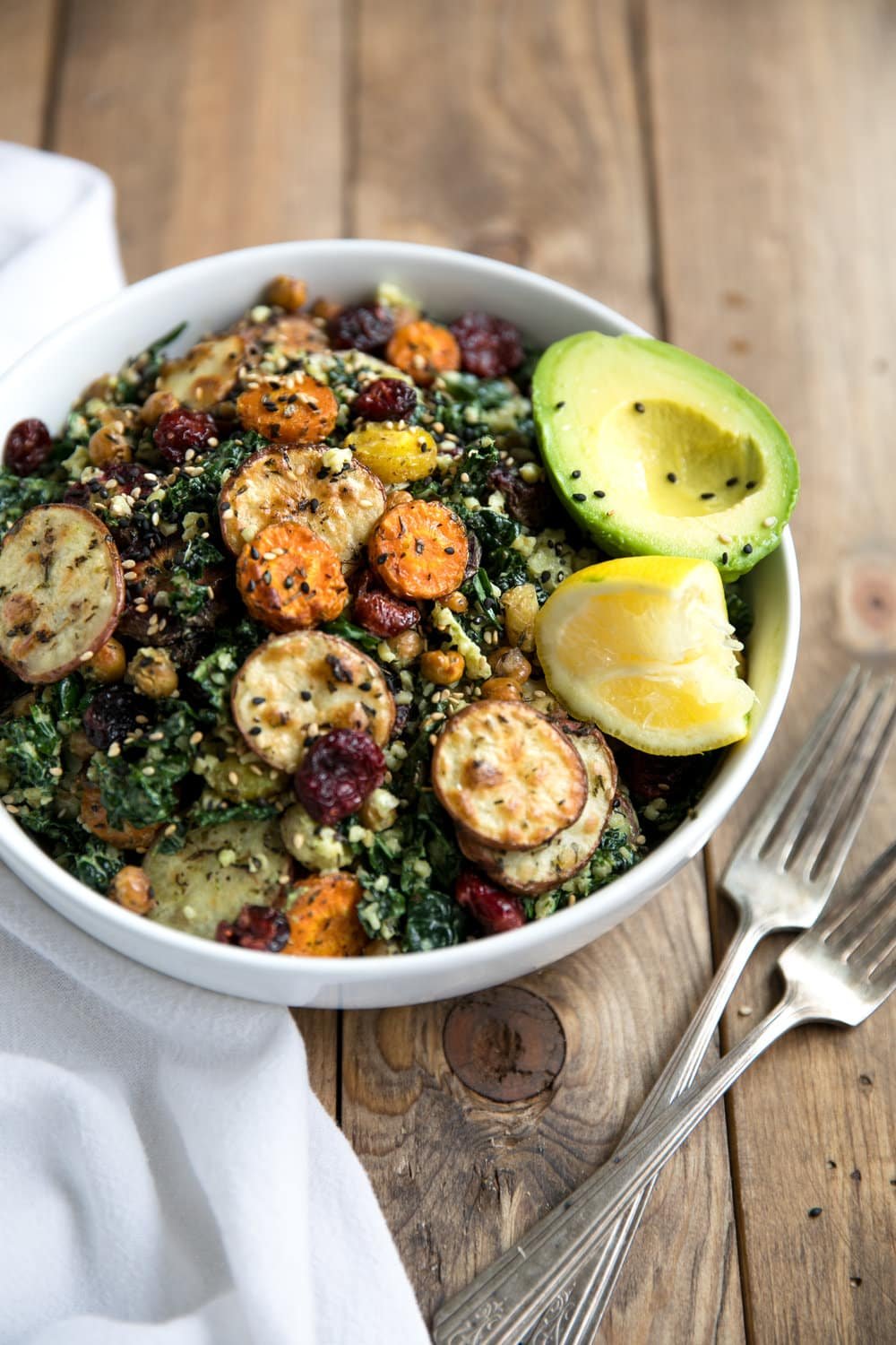 This Kale and Roasted Veggie Salad with Tahini Yogurt Pesto combines healthy, energy-packed power foods like kale, chickpeas, and carrots into one delicious bowl.