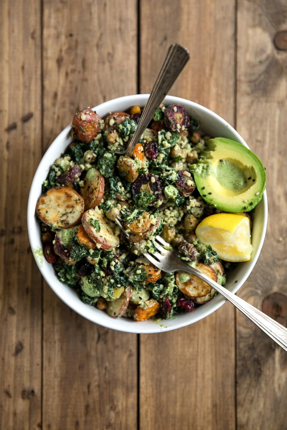 This Kale and Roasted Veggie Salad with Tahini Yogurt Pesto combines healthy, energy-packed power foods like kale, chickpeas, and carrots into one delicious bowl.