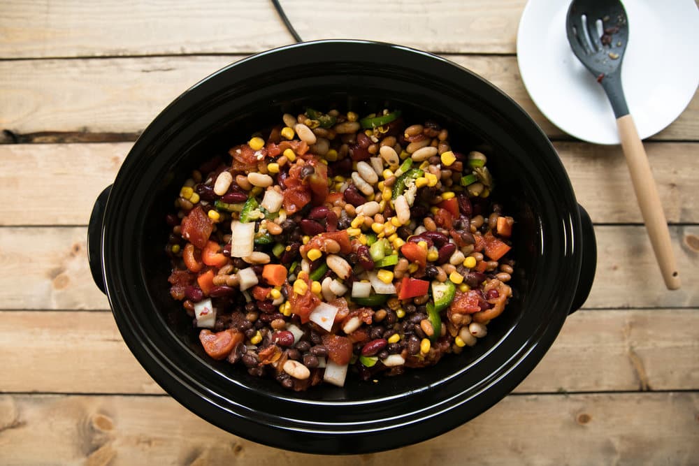 Slow Cooker Vegetarian Chili with Baked Beans. Vegetarian Chili packed full of vegetables, baked beans, corn, and tomato topped with sour cream and cheese.