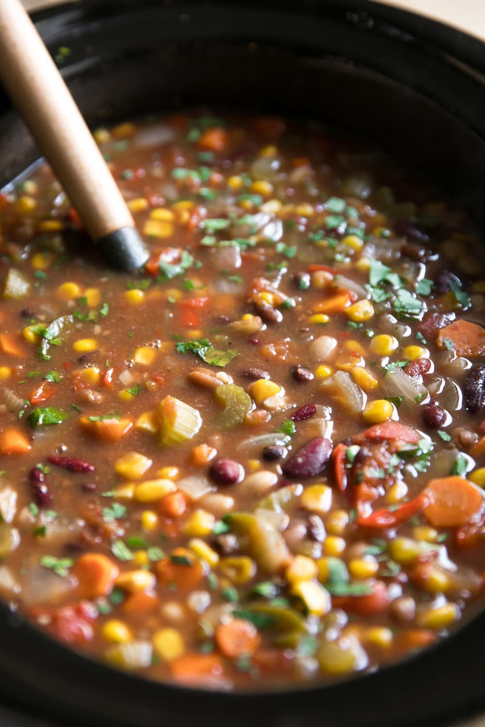 Slow Cooker Vegetarian Chili with Baked Beans. Vegetarian Chili packed full of vegetables, baked beans, corn, and tomato topped with sour cream and cheese.