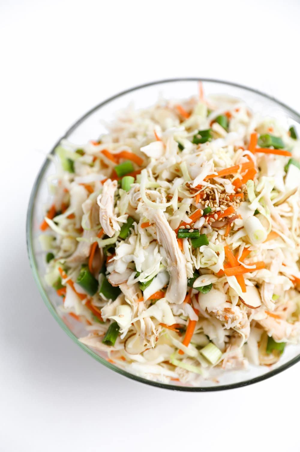 mixed chicken and cabbage salad in glass bowl