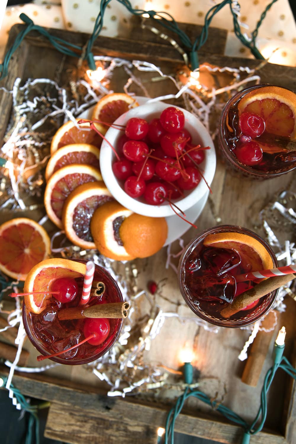 Cinnamon liqueur, bourbon, tart cherry juice, fresh orange wedges and sweet bubbly 7UP mix together to make this Orange and Cherry 7UP Spritzer; a delicious holiday cocktail