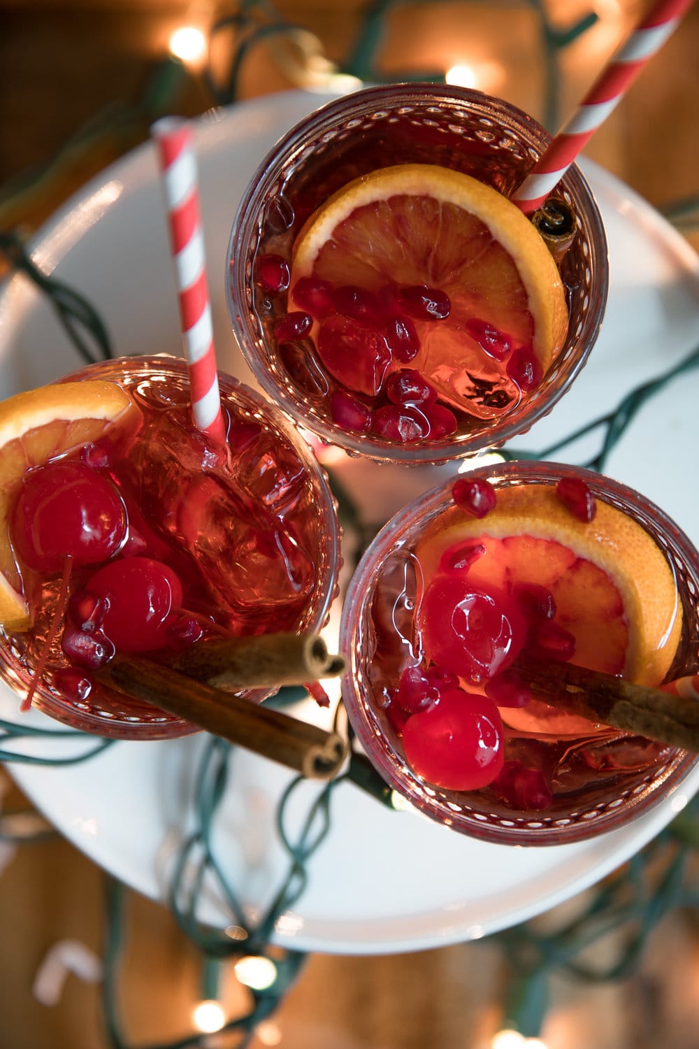 Cinnamon liqueur, bourbon, tart cherry juice, fresh orange wedges and sweet bubbly 7UP mix together to make this Orange and Cherry 7UP Spritzer; a delicious holiday cocktail